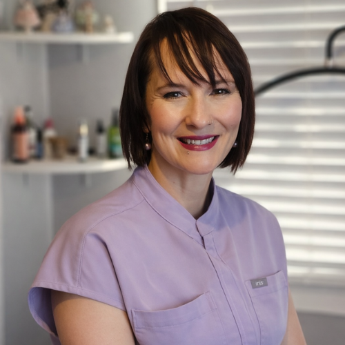 keri mills sitting and smiling in a massage room